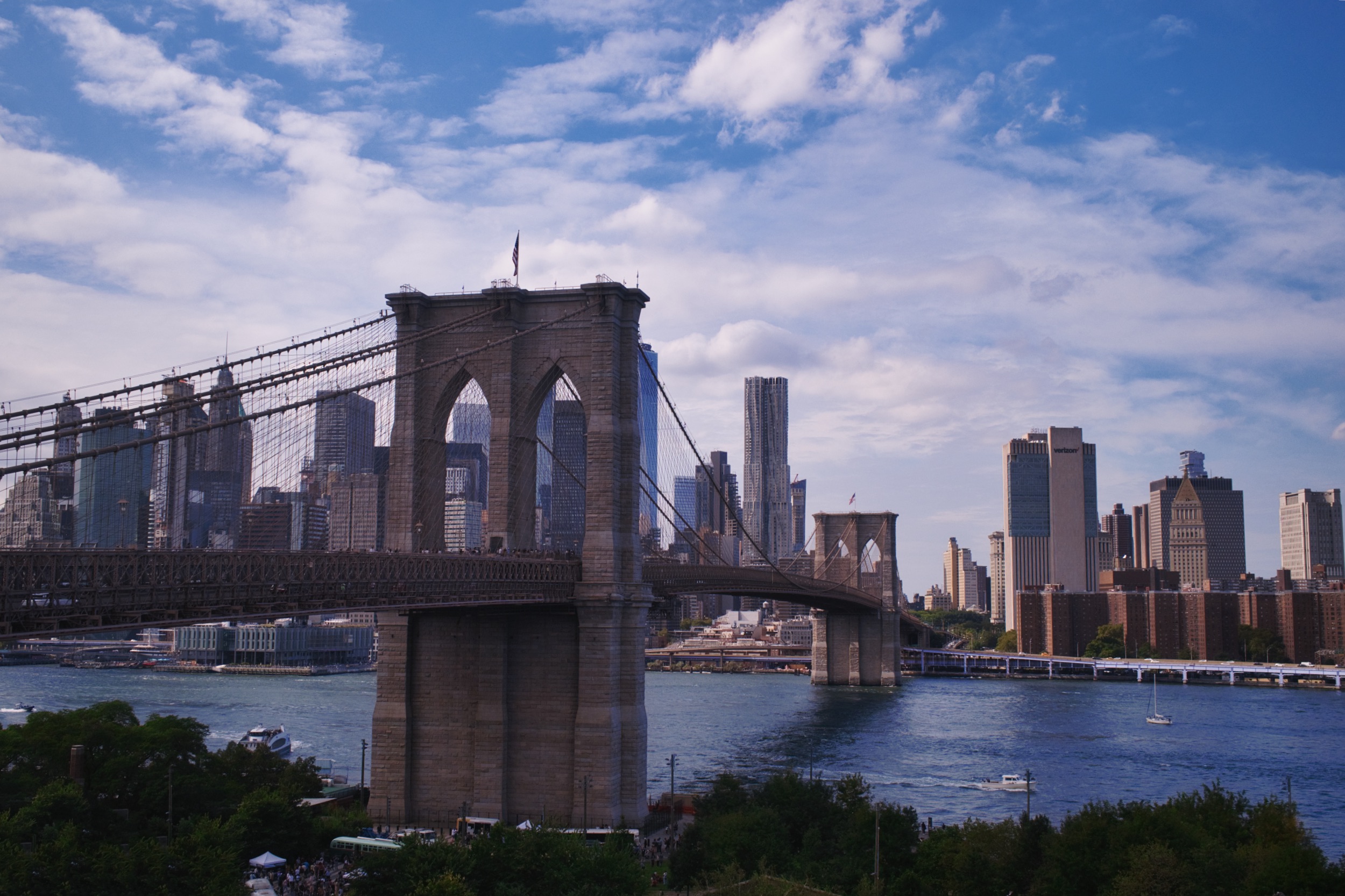 The Brooklyn Bridge and Lower Manhattan beneath a blue sky