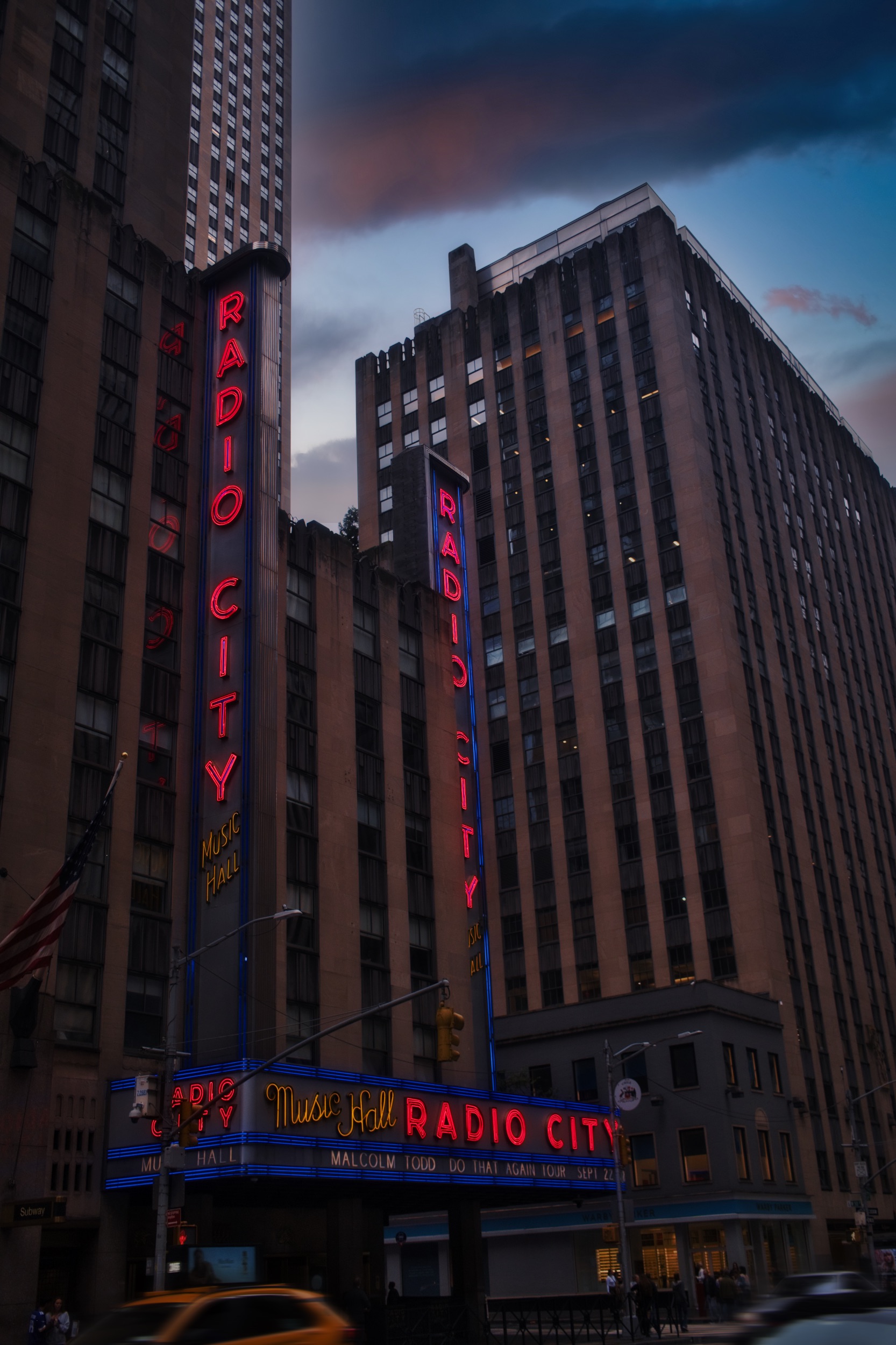 The Radio City Music Hall sign rising between Midtown buildings
