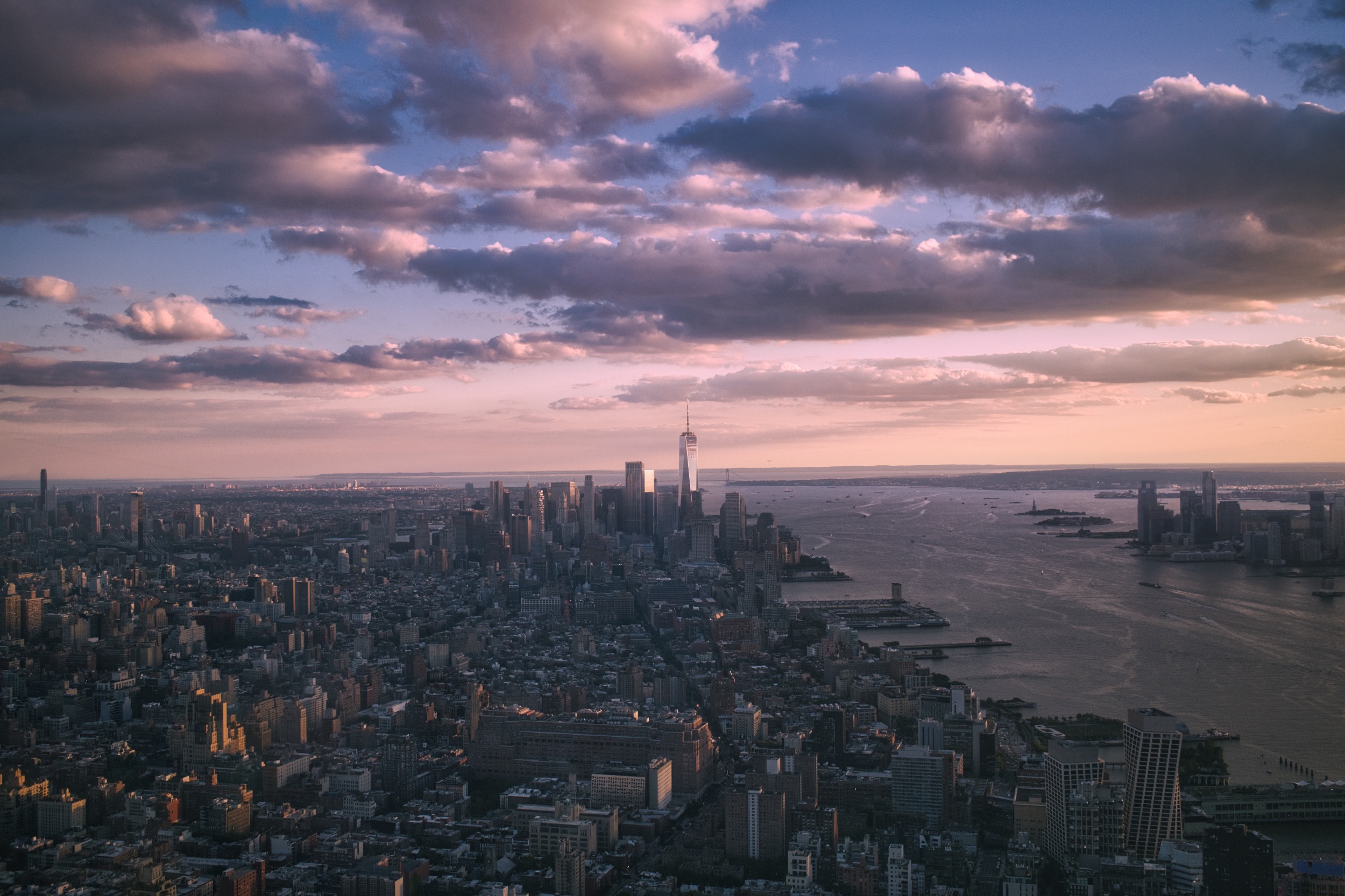New York City and the Hudson River beneath pink sunset clouds